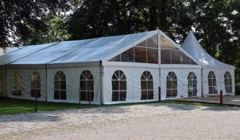 Spacious tent with clear side walls and windows set up for an outdoor corporate event or gathering in Dhaka